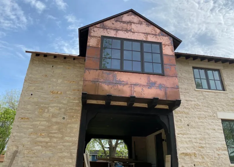 Copper metal panel facade on a stone building for Skylight Installation in South Miami Heights