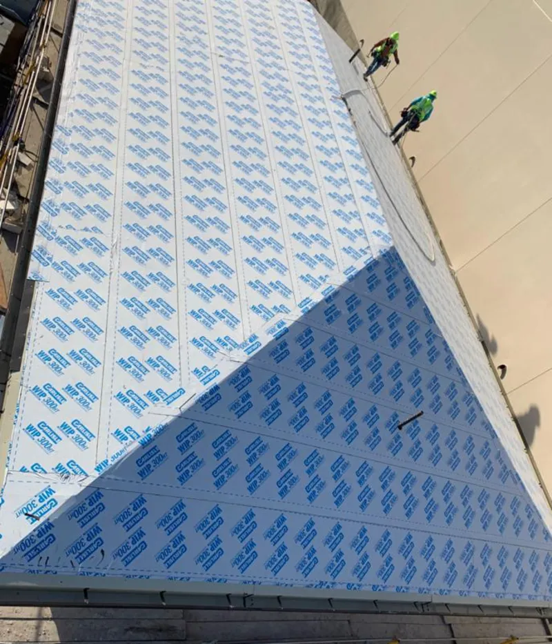 Professional roofers installing underlayment on a metal roof in South Miami Heights